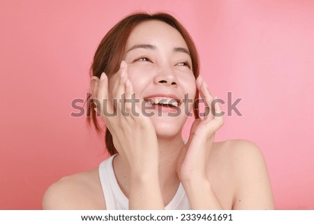 Beautiful Asian woman applying serum on face, Portrait Beautiful Asian woman in nature makeup with smiling face.