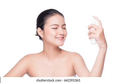 Beautiful Asian Woman Applying Spray Water On Face Isolated White Background.