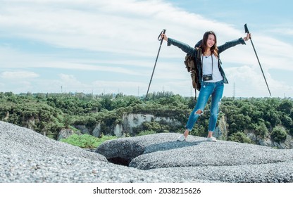 A Beautiful Asian Woman With Backpack Climbing And Standing On Top Of Mountain With Success. Travel, Vacation And Summer Concept