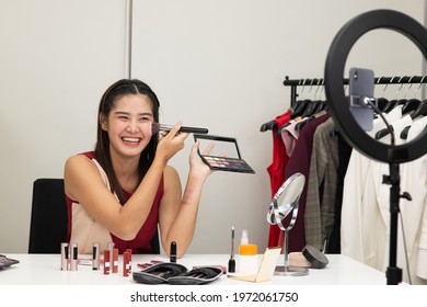 Beautiful Asian Woman Beauty Makeup Artist Vlogger Advertise Beauty Cosmetic Product On Social Media Live Streaming On Smartphone. Online Shopping Business Advertising By Blogger Or Influencer Concept