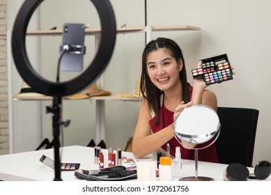 Beautiful Asian Woman Beauty Makeup Artist Vlogger Advertise Beauty Cosmetic Product On Social Media Live Streaming On Smartphone. Online Shopping Business Advertising By Blogger Or Influencer Concept