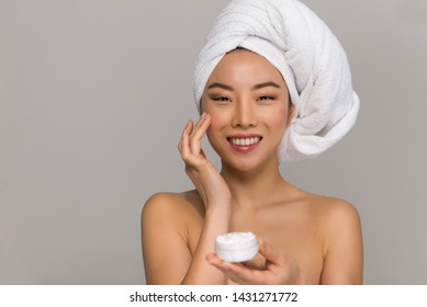 Beautiful asian woman beauty portraits. Chinese girl standing in front the mirror and taking care of her look. beauty studio shots