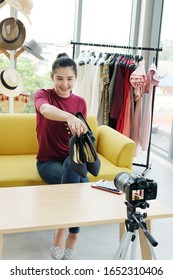 Beautiful Asian woman blogger recording on video Dslr Camera for selling shoes in shopping Vlog website. Youtber and Marketing in social media concept.