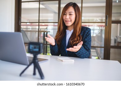 A beautiful asian woman blogger or vlogger recording a video  - Shutterstock ID 1610340670