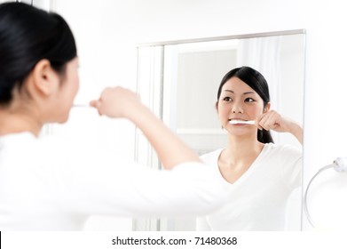 Beautiful Asian Woman Brushing Her Teeth