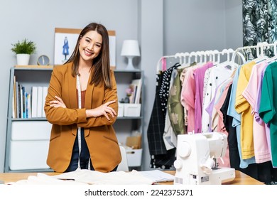 Beautiful asian woman business owner, Fashion designer standing and smile in cross arm gestures during working at fashion studio, Concept Professional Dressmaker designer - Powered by Shutterstock