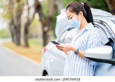 Beautiful Asian Woman In A Car Broke Down On The Road Trying To Fix The Problem And Called A Car Repair Shop Or Someone Close To Help.