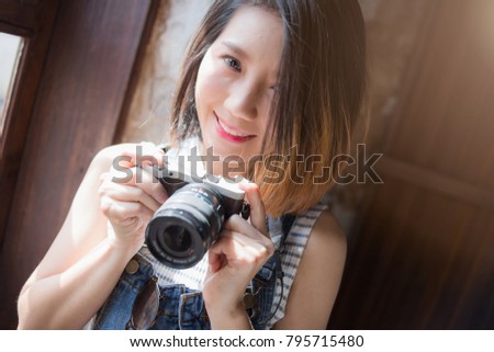 beautiful asian woman  casual costume with camera and travel stuff with background of old town city travel ideas concept