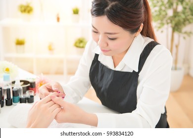 Beautiful Asian Woman Check Verify Examine Client Hand Massage And Body Care Of Nail Salon, Spa Treatments. Beauty And Fashion Concept.