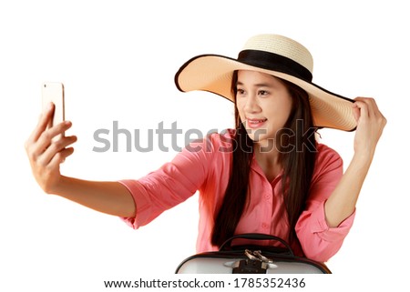 Beautiful asian woman cheerful smiling and take selfie on smart mobile phone, beauty young girl wear hat enjoy and fun in vacation isolated on white background, holiday concept. 