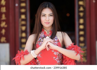 Beautiful asian woman with congratulate gesture in Chinese New Year