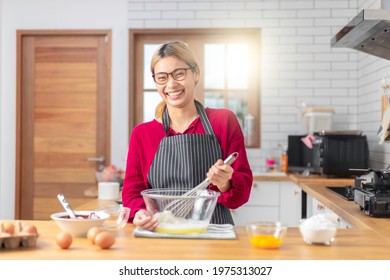 Beautiful Asian Woman Cook The Chocolate Cake With Happy Feeling In The Kitchen Room. 