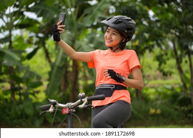 Beautiful Asian Woman Cyclist Take A Self Portrait With Smart Phone
