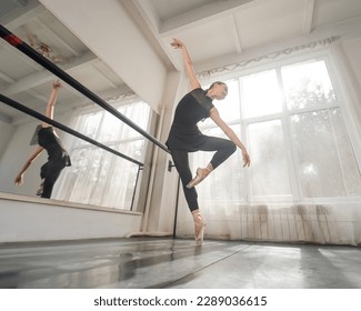 A beautiful Asian woman is dancing at the barre. Ballet dancer. - Powered by Shutterstock