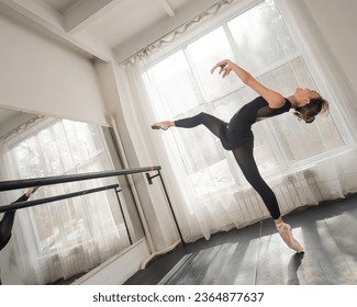 A beautiful Asian woman is dancing at the barre. Ballet dancer. - Shutterstock ID 2364877637