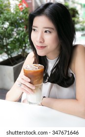 Beautiful Asian Woman Drinking Ice Coffee