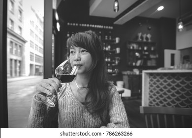 Beautiful Asian Woman Drinking Wine In Black And White. Red Wine Concept