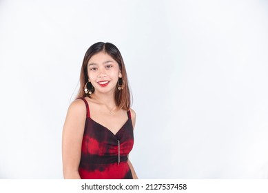 A Beautiful Asian Woman With Dyed Hair And Red Lipstick, Wearing A Red Casual Dress. Isolated On A White Background.