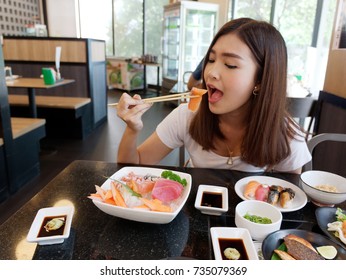 Beautiful Asian Woman Eating Sashimi, Japanese Food.