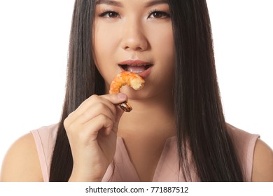 Beautiful Asian Woman Eating Shrimp On White Background