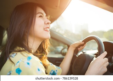 Beautiful Asian Woman Enjoying Life  In The Red Car.