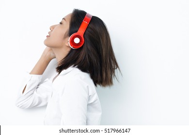 Beautiful Asian Woman Enjoying Listening To Music