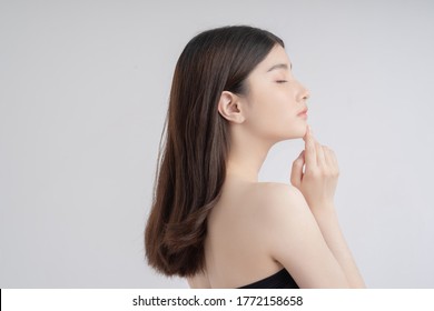 Beautiful Asian Woman With A Beautiful Face . Side View .She Touches Her Chin 