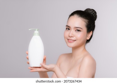 Beautiful Asian Woman Holding Bottle With Moisturising Lotion