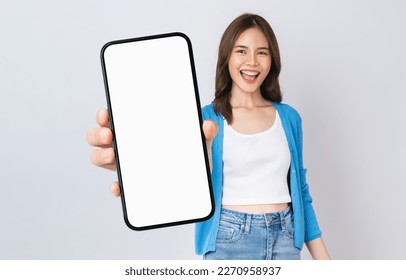 Beautiful Asian woman holding smartphone mockup of blank screen and smiling on white background. - Shutterstock ID 2270958937