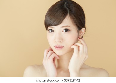 Beautiful asian woman isolated on beige background