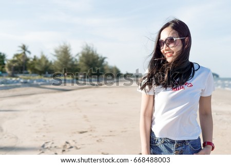 A beautiful asian woman jumping with feeling happy on the beach. copy space