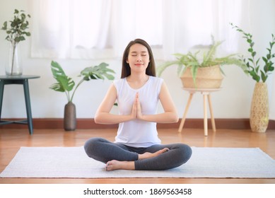 Beautiful Asian Woman Keep Calm And Meditates While Practicing Yoga At Home For Healthy Trend Lifestyle