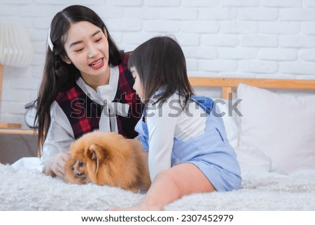 Beautiful asian woman and little girl bond grew stronger with each shared moment as they laughed played and enjoyed the simple pleasures of being together on bed in bedroom.