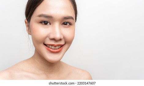 Beautiful Asian Woman, Natural Cosmetic Skincare Products Look At Camera, Smiling, Touching Face And Healthy Skin In Slow Motion, Wellness. Beauty Portrait.