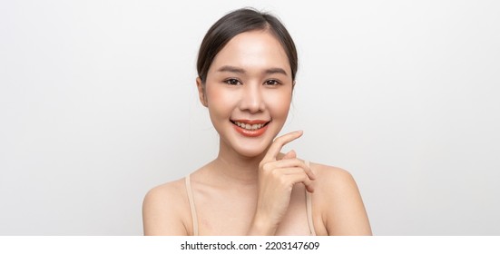 Beautiful Asian Woman, Natural Cosmetic Skincare Products Look At Camera, Smiling, Touching Face And Healthy Skin In Slow Motion, Wellness. Beauty Portrait.