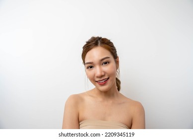 Beautiful Asian Woman, Natural Cosmetic Skincare Products Look At Camera, Smiling, Touching Face And Healthy Skin In Slow Motion, Wellness. Beauty Portrait.