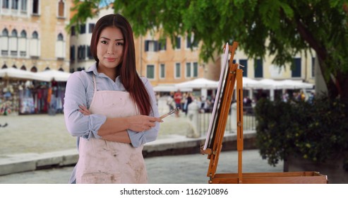 Beautiful Asian Woman In Painters Smock Standing On Venice Street With Tourism 