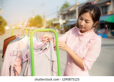 Beautiful Asian Woman In Pink Dress To Hang Dry The Clothes Outside With Sweat On Face