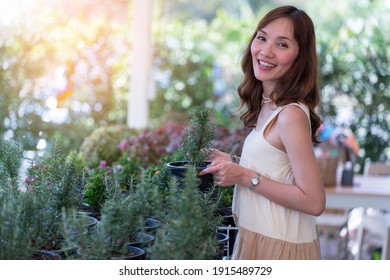 A Beautiful Asian Woman Planted Trees For Sale In A Tree Shop. Work Form Home Concept