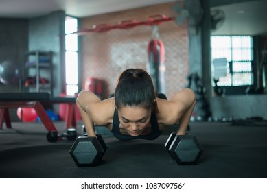 Beautiful Asian Woman Play Fitness In The Gym,Thailand Girl Has A Slim Body,Time For Exercise,People Love Heath,Stretching Body Before Workout,Sport Woman Warm Up Body,push Up With Dumbell