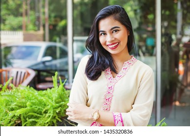 Beautiful Asian Woman Posing In Indian Traditional Clothes (kurta) And Looking At Camera