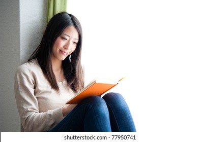 Beautiful Asian Woman Reading A Book