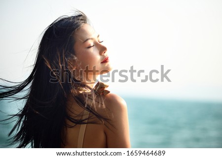 Beautiful Asian woman with seascape background 