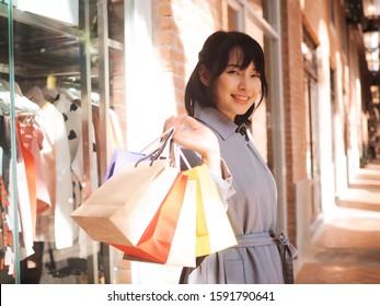 Beautiful Asian Woman With Shopping Bag In Outlet Mall.