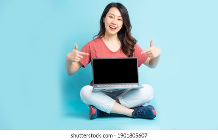 Beautiful Asian Woman Sitting Pointing At The Laptop
