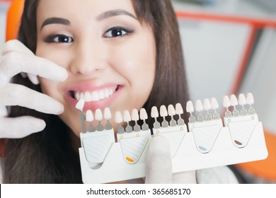 Beautiful Asian Woman Smile With Healthy Teeth Whitening. Dental Care Concept. Set Of Implants With Various Shades Of Tone