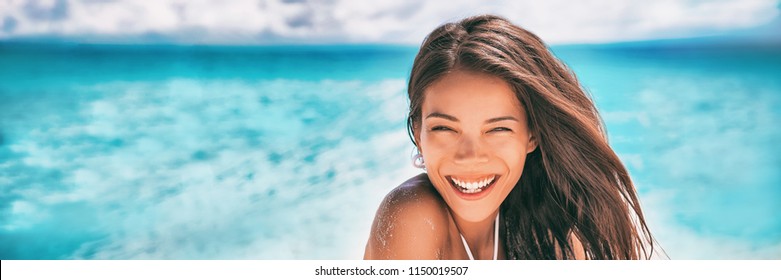 Beautiful Asian woman smiling relaxing on summer beach sunbathing banner panorama.