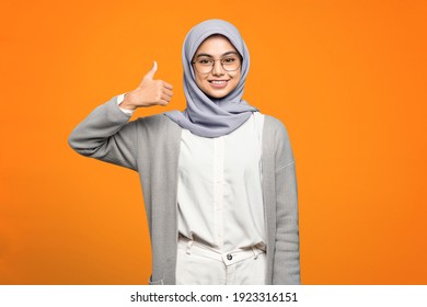 Beautiful Asian woman smiling and showing thumbs up