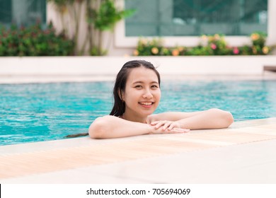 Beautiful Asian Woman Smiling In A Swimming Pool