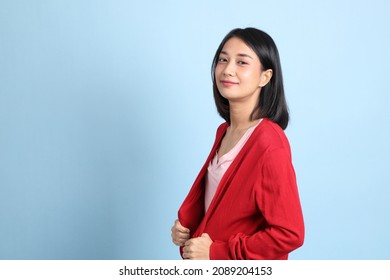 The beautiful Asian woman standing on the blue background. - Shutterstock ID 2089204153